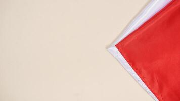 Red and White National Flag of Indonesia with Copy Space Area on Light Background photo