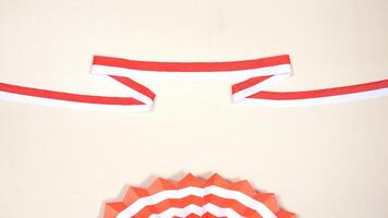 Red and White Ribbons as Symbol of Indonesia National Flag and Paper Decorations with Copy Space Area on Light Background photo