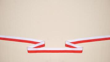 Red and White Ribbons as Symbol of Indonesia National Flag with Copy Space Area photo