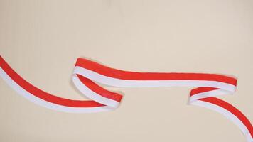 Red and White Ribbons as Symbol of Indonesia Flag with Copy Space Area photo