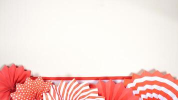Independence Day of Indonesia Concept with Red and White Ribbons, and Paper Decorations on Light Background photo