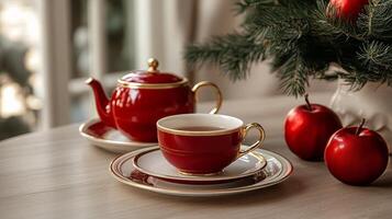 A red tea pot and saucer on a table photo