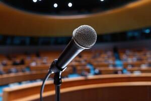Microphone in the conference hall or seminar room with blurred background. photo