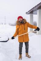 Man removing snow and ice from the sidewalk in front of house. Winter season photo