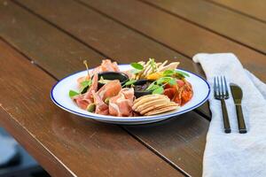 A plate of food on a table with a napkin photo