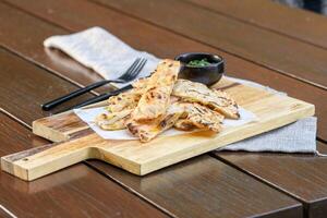 A wooden cutting board with some food on it photo