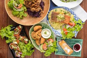 A table with various dishes of food on it photo