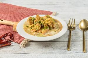 A plate of food with a fork and spoon on a table photo