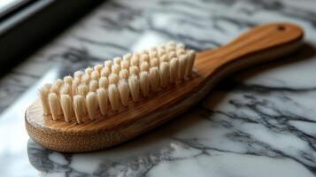 A wooden brush sitting on a marble counter photo