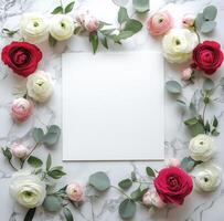 Floral arrangement with mixed roses and blank canvas on marble surface for artistic display photo