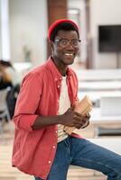 Happy smiling mixed race student guy in glasses hold textbooks show thumbs up gesture look at camera photo
