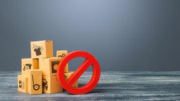 Cardboard boxes and red prohibition symbol NO. Import restriction, ban export of dual-use goods to countries under sanctions. Out of stock. Embargo trade wars. Border closure, quarantine and isolation photo