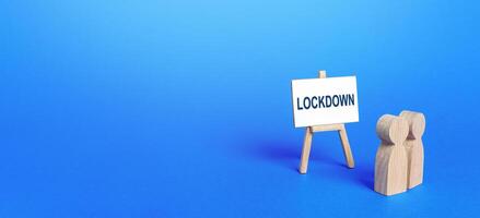 Figures of houses and an easel with the word Lockdown. photo