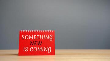 Note with the words something new is coming. Something must happen soon. Coming soon. Motivation and inspiration concept photo