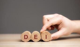 Wooden blocks with the word DEI - Diversity equity inclusion. Values held by many organizations that are working to be supportive of different groups of individuals photo
