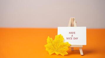 Easel with message Have a nice day and autumn leaf. Concept of good start to day photo
