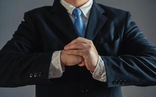 Businessman flexing his fists. Concept of readiness to take on something serious. Accepting a challenge. Competition and rivalry. Full dedication to work. Overcome challenges. photo