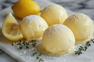Scoops of refreshing lemon ice cream melting on marble surface with thyme and powdered sugar photo