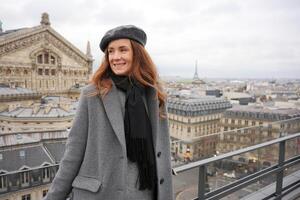 Smiling Woman on a Rooftop in Paris with Eiffel Tower View photo