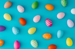 Colorful pattern composition made of various colored Easter eggs on light blue background. Minimal Easter concept. Creative festive spring holiday backdrop. Easter aesthetic. Flat lay, top of view. photo