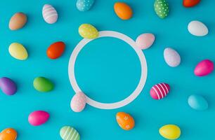 Colorful pattern composition made of various colored Easter eggs on light blue background with copy space. Minimal Easter concept. Creative festive spring holiday layout. Flat lay, top of view. photo