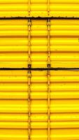 close-up view of vibrant yellow corrugated metal texture photo