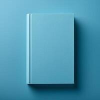 Blue book with blank hard cover on matching backdrop. Minimalist template design. Flat lay. Mock-up photo