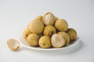 Fresh Langsat Fruit Piled on a Plate with White Background Display photo