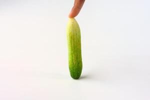 Fresh Green Cucumber Upright With Finger Touch on White Background photo