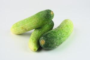 Fresh Green Cucumbers Arranged on a Clean White Background for Culinary Use photo