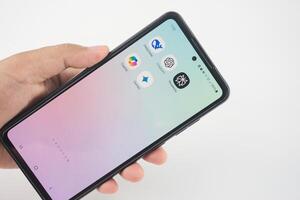 Sleman, Indonesia February 04, 2025 Hand holding a smartphone displaying various AI-related application icons on the screen. Such as Deepseek, ChatGPT, Copilot, Gemini, and Perplexity photo