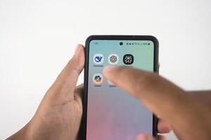 Sleman, Indonesia February 04, 2025 Person's hand using a smartphone to select an Aetificial Intelligence Apps icon on its touchscreen. Such as Deepseek, ChatGPT, Copilot, Gemini, and Perplexity photo