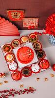 Top View of Chinese New Year Food with Chinese Poster Background and Ornaments. photo