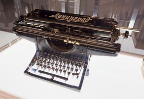 A detailed view of a Soviet-era Leningrad typewriter with Cyrillic keys and elegant retro design. A historical artifact showcasing craftsmanship and utility from mid-20th-century Russia photo
