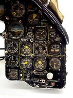 A detailed view of a Soviet aircraft cockpit instrument panel, showcasing an array of gauges, switches, and controls. This intricate setup highlights the precision engineering and functionality of mid photo