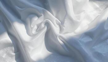 Elegant white fabric with soft shadows, texture and delicate folds in natural sunlight photo