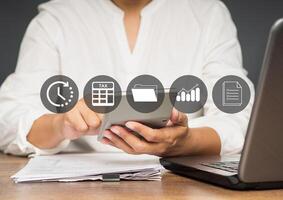 Close-up of the hand using a calculator to calculate taxes while sitting in the office photo