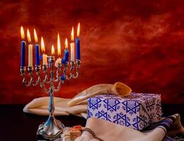 Jewish holiday Hanukkah creative background with menorah. View from above with focus on menorah. photo