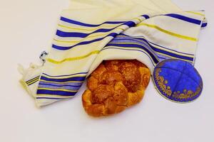 A table set for Shabbat with lighted candles, challah bread and wine. photo