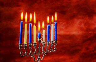 Jewish holiday Hanukkah creative background with menorah. View from above with focus on menorah. photo