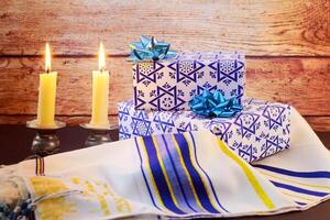 A table set for Shabbat with lighted candles, challah bread and wine. photo