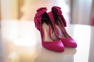 high heeled shoes with trendy accessories, captured on a colorful background, exuding luxury and elegance photo