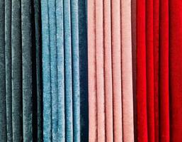 Colorful fabric samples hanging in a store, showcasing a variety of textures and colors photo