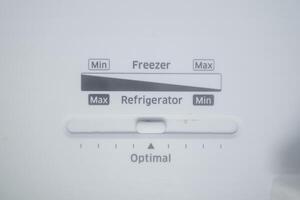 Refrigerator and freezer temperature control button photo