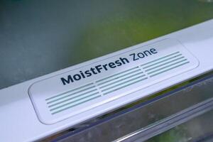 Moist Fresh zone drawer in the refrigerator. A special storage space in the refrigerator for fruits and vegetables photo