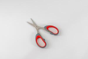 An open pair of scissors on a white background photo