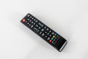 A tv remote with many buttons on white background photo