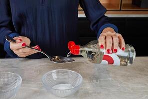 Hands stirring seasoned sushi rice in a bamboo bowl using a wooden spatula, an essential step in sushi preparation. photo