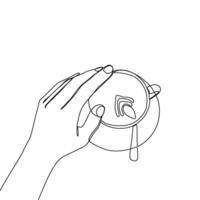 A hand holding a cup with a spoon in it vector