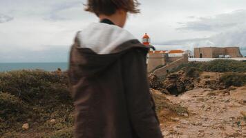 Boy tourist in Portugal taking photos of Cape St. Vincent Lighthouse video